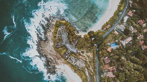 nature aerial photography of houses and buildings near body of water aerial view